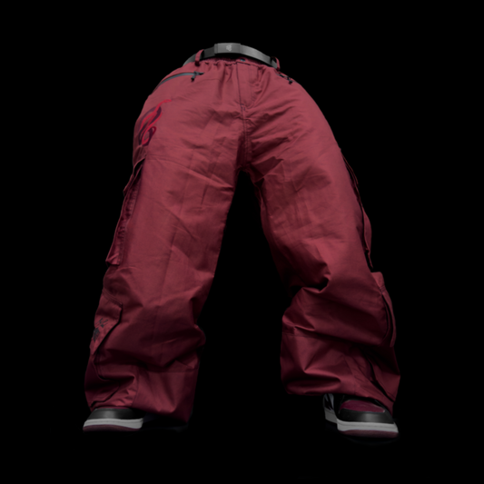 Baggy maroon snowpants, ideal for snowboarding and skiing. These are durable, and waterproof pants.  showcasing a stylish look for both ski and snowboard enthusiasts. Perfectly crafted to combine fashion and function, these baggy ski pants ensure comfort and mobility on the slopes.